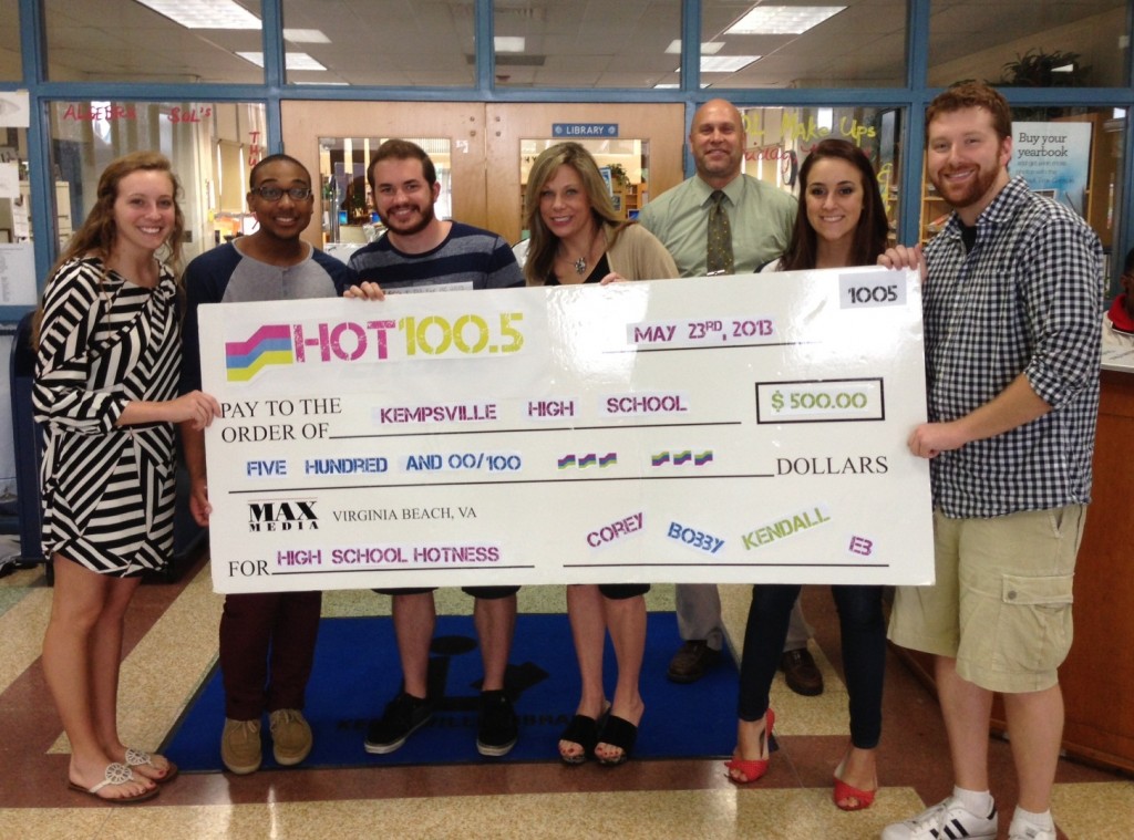 Students Casey Smith, Kempsville's junior class president and Jorge Newby, senior class president, stand with Hot 100.5 staff and Student Activities Coordinator Tim Wolf. 