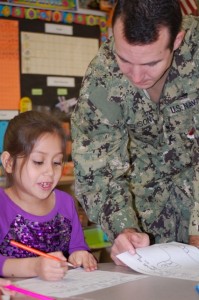 HM2 Dallas Burelison assists Kempsville first-grader Karyme Ayala during literacy centers.