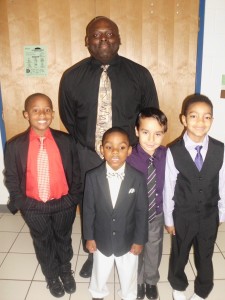 Diamond Springs Custodian Darrin Hawes with first grade students:  Tyree H, Marzir H., Charlie C. and Talle A. during the first Distinguished Young Gentlemen's Assemby.