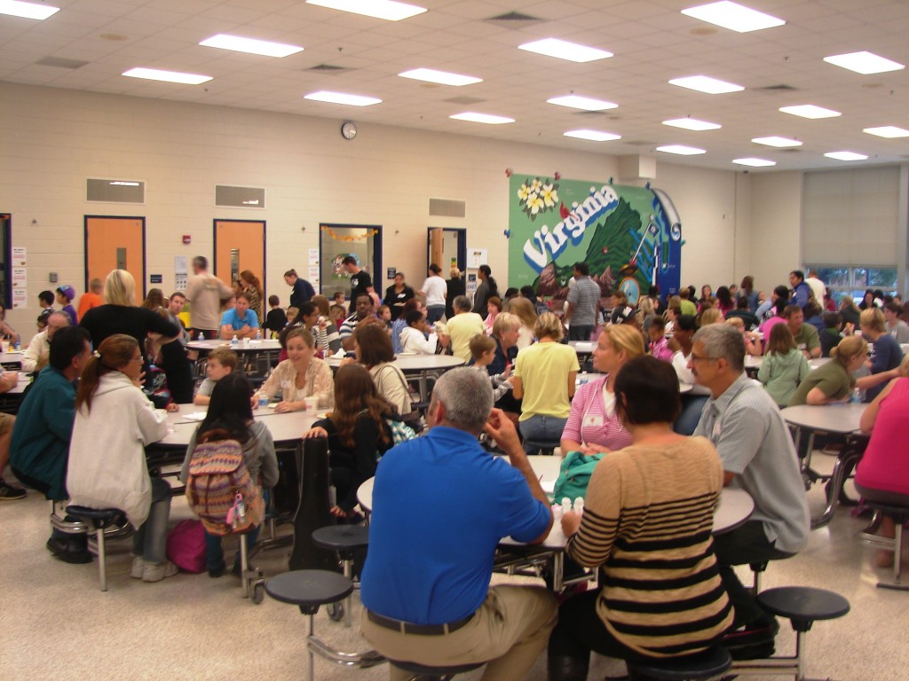 Families enjoy their pastries while watching the morning announcements. 