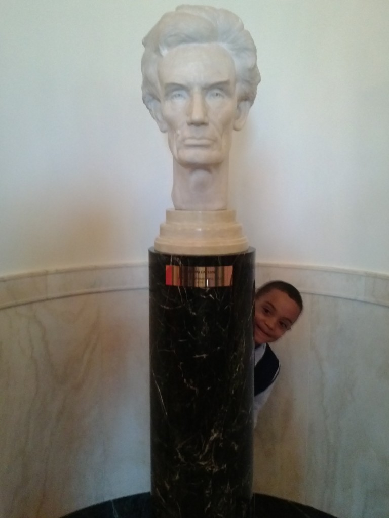 Christopher Pulley smiles behind his favorite president, Abraham Lincoln. 