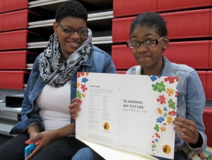 India Griswell looks over the packet of summer activities with her mother, Jamila Griswell.