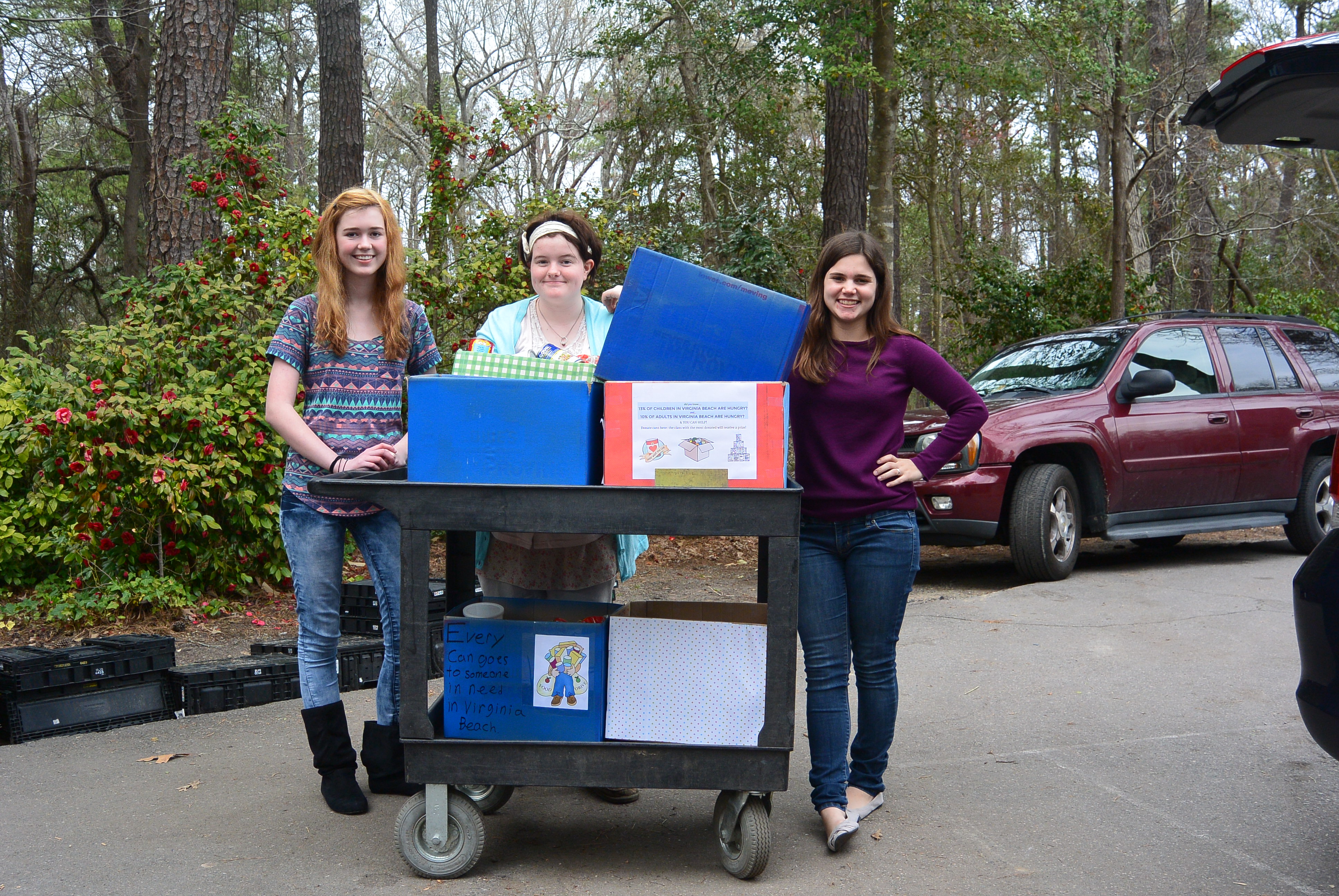 First Colonial's Isabel Bennett, Katelyn Leech and  Kelsey Terry (now a graduate) deliver food that was donated to help aid hunger relief efforts in the area. 