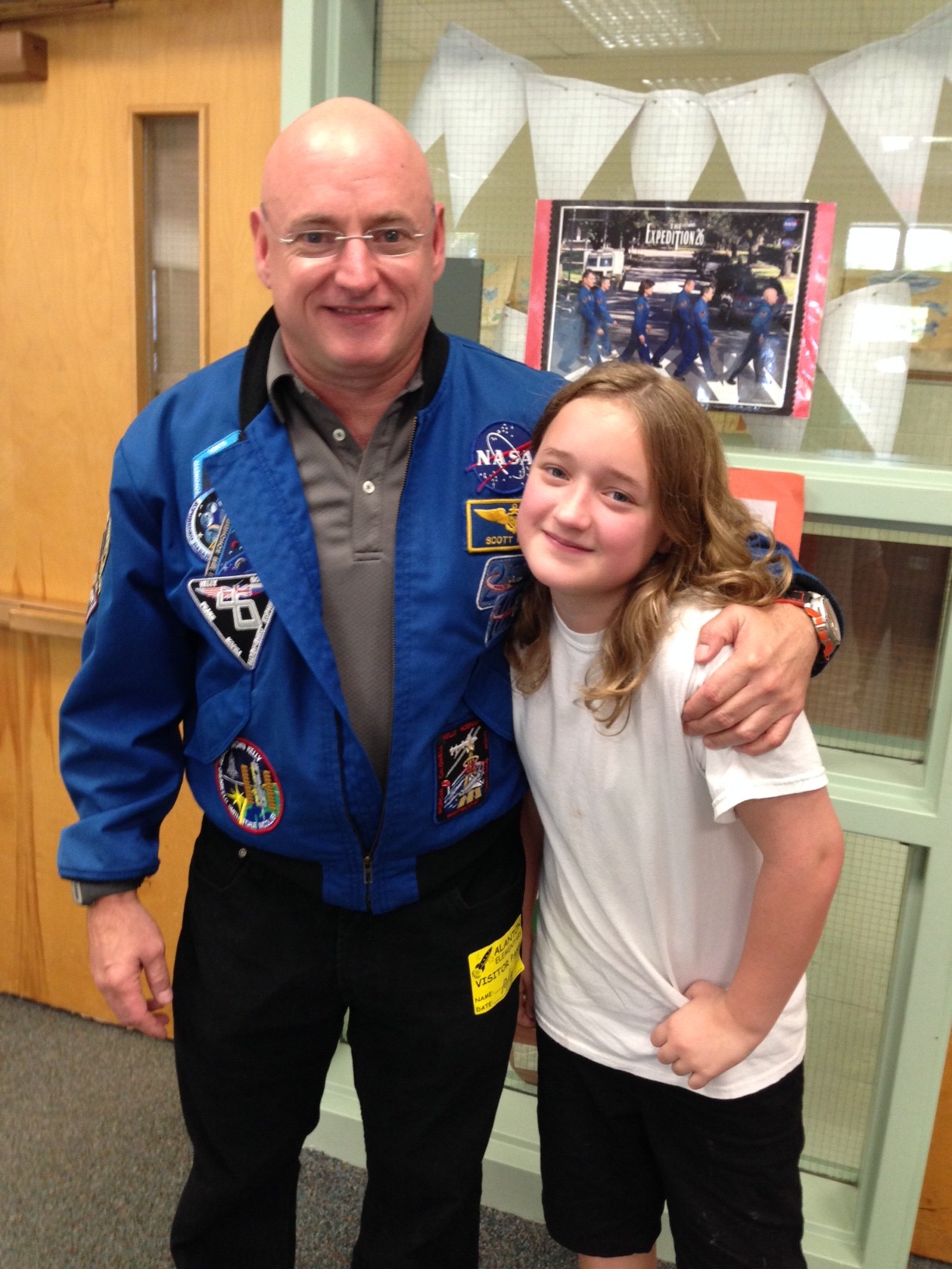 Kelly, takes a photo with his daughter, Charlotte, a student at Alanton Elementary. 