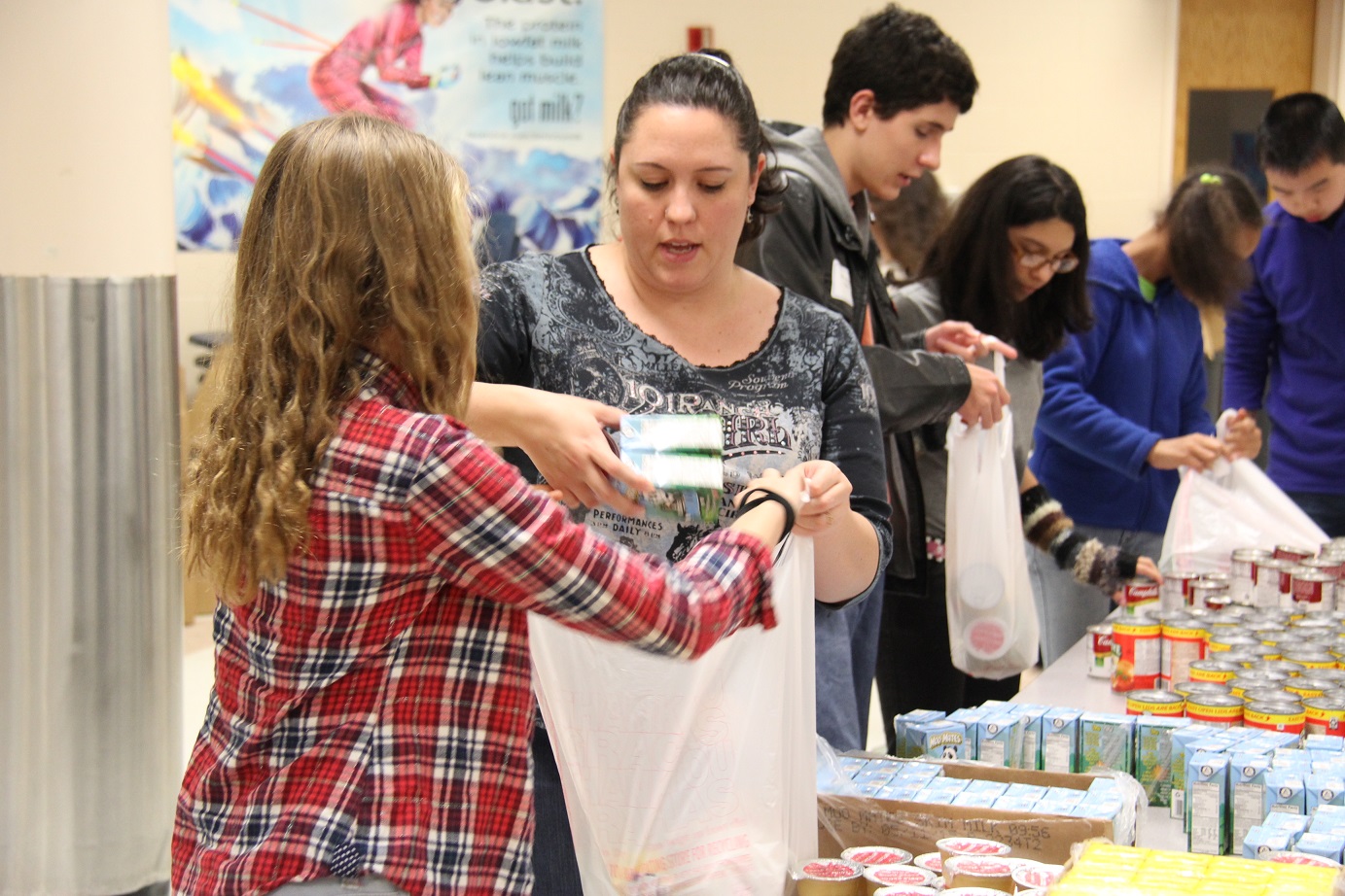Volunteers created assembly lines to pack Beach Bags with non-perishable food.