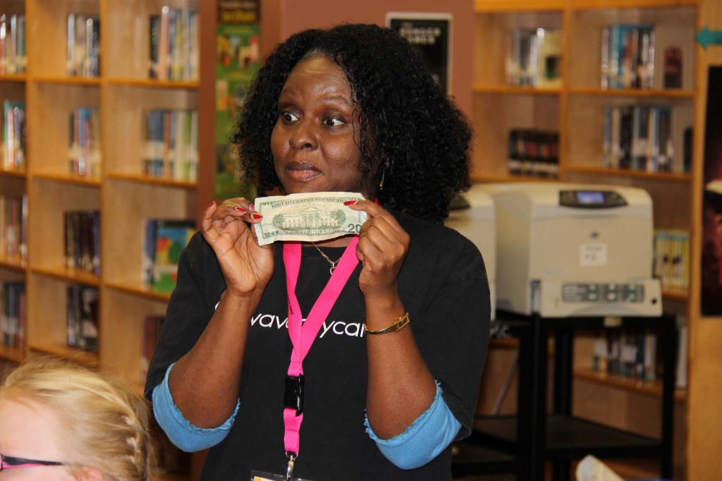 Mentor Sandra Jett uses a $20 bill for an activity about self-worth and value. 