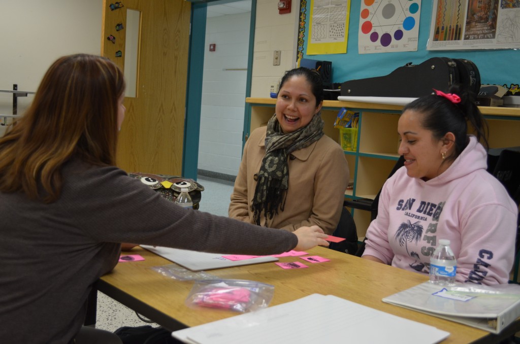  Sheryl Cholish demonstrates a word match with Midian Pena and Maria Solis. 