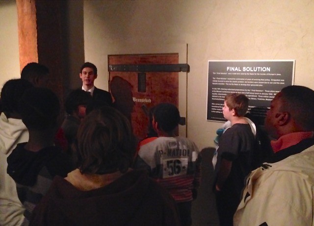 A guide at the Virginia Holocaust Museum prepares students before they enter the model gas chamber disguised as a shower during the holocaust period.