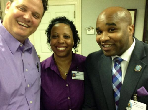 Dr. Aaron Spence, Cheryl Woodhouse and Rashard Wright proudly don their purple