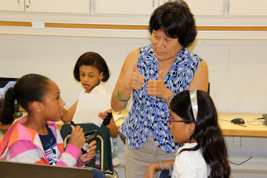 Chinese teacher Lili Chao works with students.